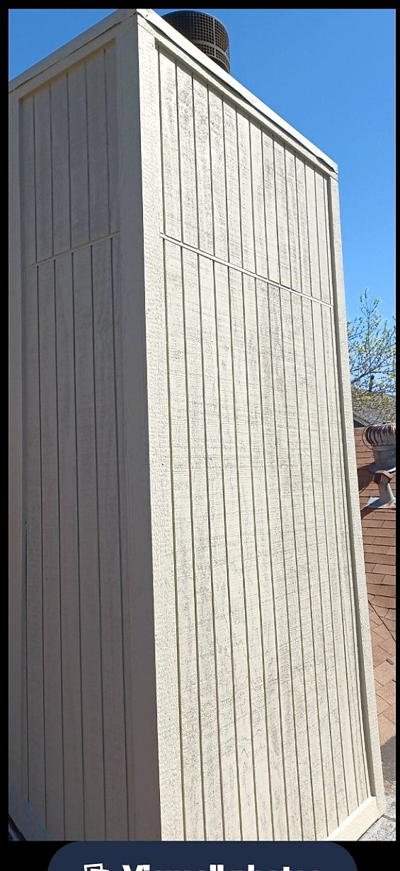 Chimney chase after damaged wood replacement, new trim, caulking, and brown finish paint in the Austin area.