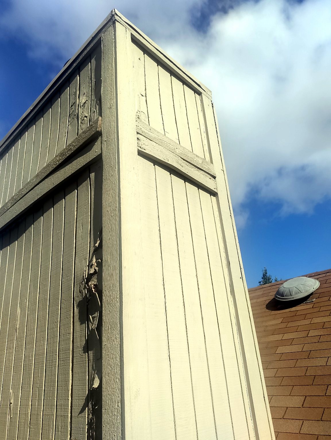 Damaged exterior wood siding and trim on a chimney chase before repair in Austin.