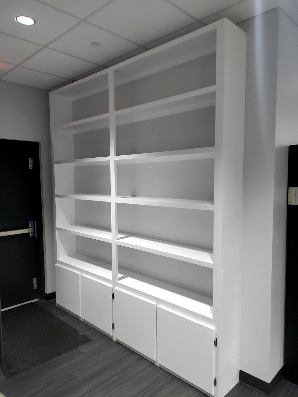 Custom built-in shelving and lower storage cabinets built by Affordable Handyman Services in the Austin area.