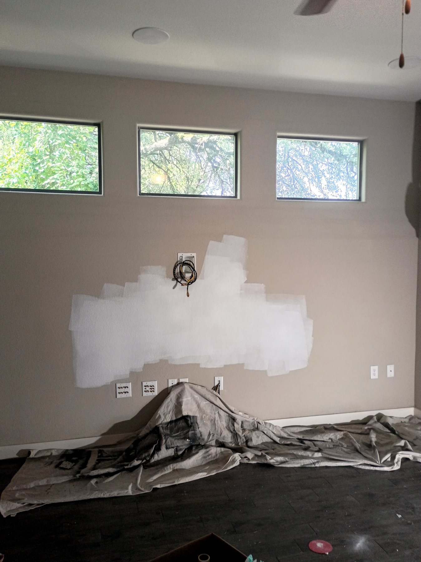 Interior wall repairs prepared for texture, primer, and paint during an Austin residential make-ready.