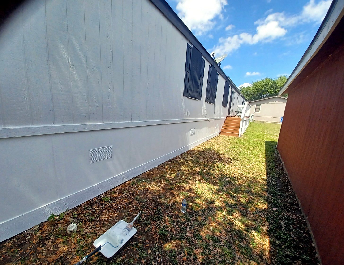 Manufactured-home exterior after repair work and a paint refresh in the Austin area.