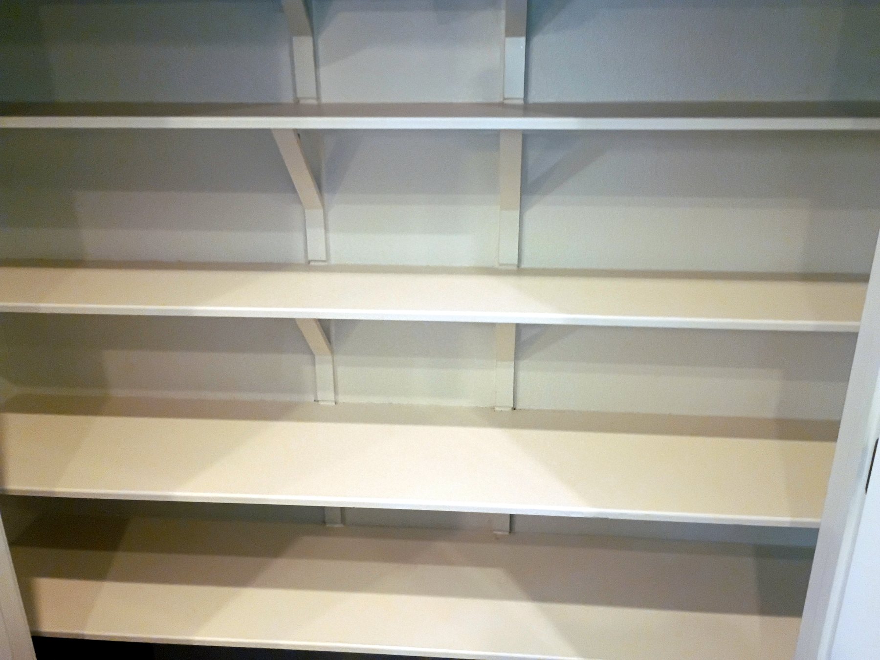 Existing pantry shelving repainted and refreshed during an Austin whole-home make-ready.