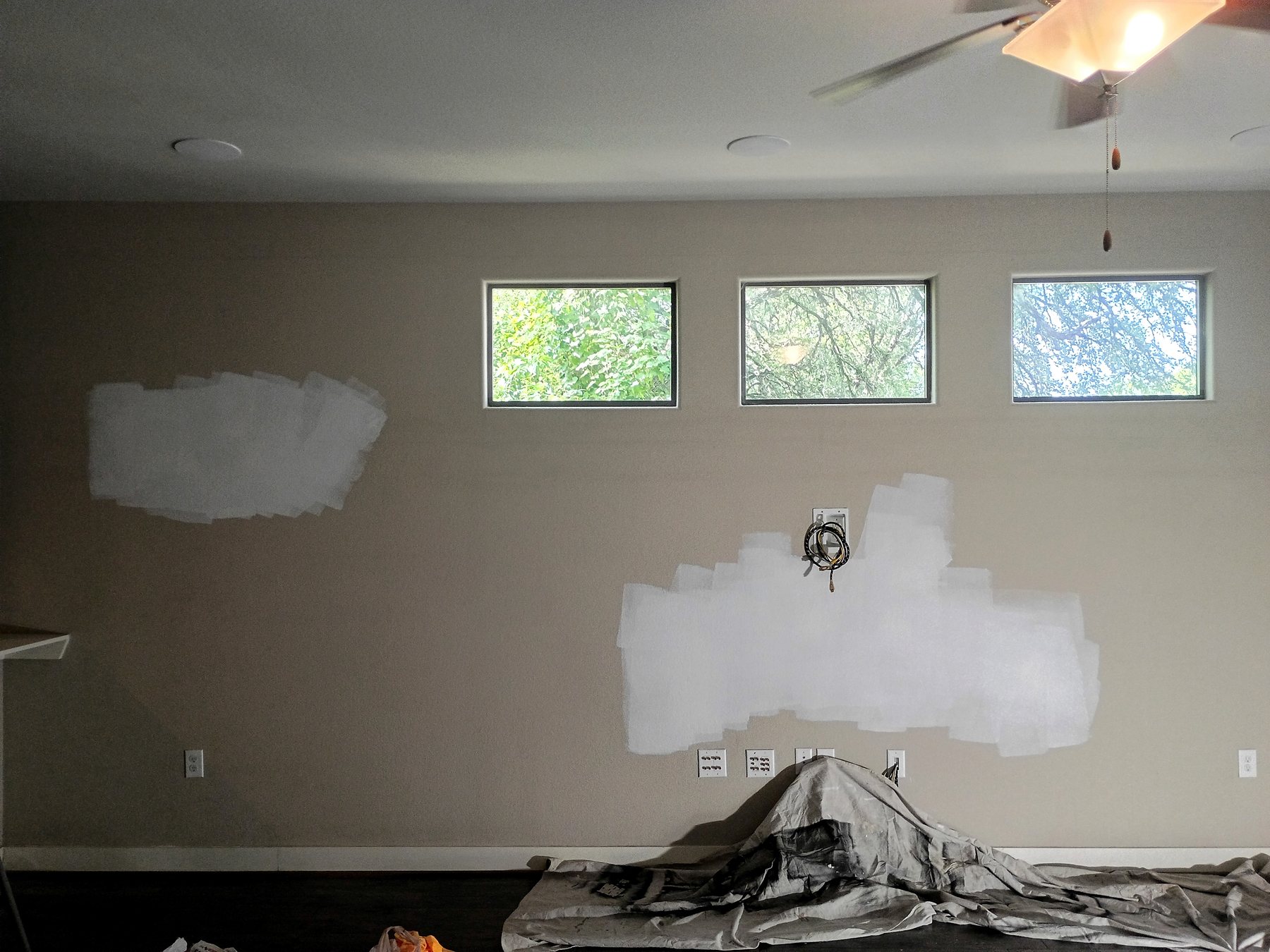 Multiple interior wall patches prepared for texture matching, primer, and final paint in Austin.